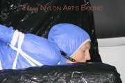***SEXY SANDRA*** wearing a supersexy skinny shiny nylon pants and a lightblue shiny nylon rain jacket being bound on a sofa with ropes and a ball gag (Pics)