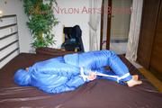 Jill tied, gagged and hooded on bed wearing a supersexy supershiny lightblue downwear (Pics)