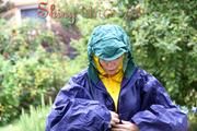 Jill Diamond in the garden playing with water out of the garden hose wearing supersexy shiny nylon rainwear and a rain cape (Pics)