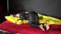 Sexy Sandra wearing sexy shiny nylon rainwear lolling in bed of nylon (Video)