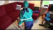 Mara tied, gagged and hooded on the back of an chair wearing a hot rain pants and a shiny nylon shorts over it and a rain jacket (Video)