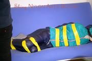 Mara tied and gagged with tape on a sofa wearing a supersexy shiny blue rain pants and a grren rain jacket (Pics) 