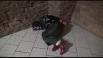 Jill tied, gagged and hooded on a cellar floor wearing a shiny green rain pants and a shiny black down jacket (Video)