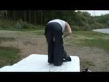 Enni wearing shiny nylon shorts and a rain jacket as well as a rain pants over the shorts (Video)
