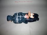 One of our archive girls tied and gagged in shiny nylon rainwear
