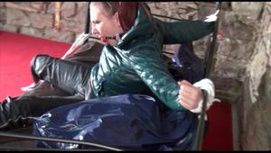Mara tied and gagged on a princess bed in an old cellar wearing an supersexy shiny green down jacket and a rain pants (Video)