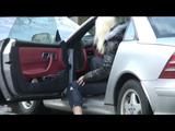 Blonde-haired archive girl going out wearing shiny nylon rainwear (Video)