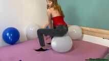 sitpopping nine U16 balloons on the bed
