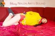 ***LUCIE*** wearing red/yellow shiny nylon shorts and a yellow shiny nylon rain jacket being bound on a sofa with ropes and a ball gag (Pics)