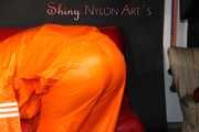 Watching Pia putting on a wonderful supersexy shiny nylon rainssuit in orange (Pics)