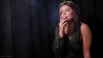 Asya is giving an interview while smoking two cigarettes