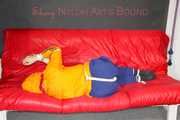 Lucy tied and gagged on a sofa wearing an orange shiny nylon rain jacket and a blue rain pants (Pics)