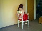 Lady in Red on a chair 1/2
