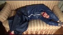Mara tied, gagged and hooded on an old sofa wearing a cool blue rain skirt and a jacket as well as rubber boots (Video)