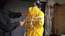 Watch Lady M bound in a yellow Rainsuit wearing a latex Hood and a Gasmask
