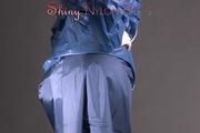 Mara posing in the studio wearing a blue rain skirt and a blue rain jacket as wellas red rubber boots (Pics)