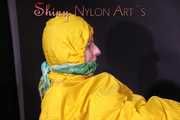 Watching sexy Pia being tied and gagged with ropes on a bed and a clothgag wearing sexy yellow shiny nylon rainwear (Pics)