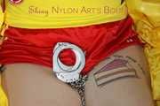 SEXY MARA ties and gagges herself with cuffs and a ball gag wearing a sexy red/yellow shiny nylon shorts and a sexy yellow top (Pics)