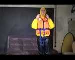 Sexy Mara trying on her new yellow down jacket and her lifevest in combination with a sexy shiny black rain pants and rubber boots (Video)