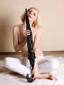Topless barefoot Hannah, bound with her hands tied up in front of her, poses with umbrella