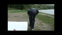 Sexy archive girl wearing shiny nylon shorts and puts on a rain pants and jacket (Video)