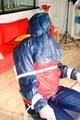 Katharina tied and gagged in a shiny nylon rainsuit