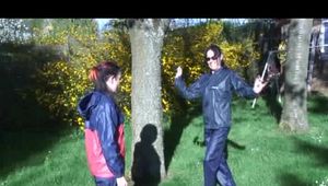 Jill and a friend of her playing with eachother in the garden while wearing shiny nylon rainwear (Video)