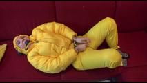 Jill ties, gagges and hoodes herself wearing a shiny yellow down jacket and a yellow rain pants(Video)