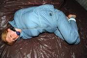 Katharina tied and gagged in a blue skisuit