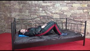 Jill ties and gagges herself sitting on a princess bed in an old cellar wearing sexy black shiny nylon down wear (Video)