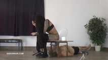 Mistress Cleo squirts cologne into the mouth of the slave lying in the toilet.