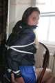 Stella being tied and gagged with ropes and a clothgag on a chair wearing a sexy shiny nylon short and a rain jacket (Pics)