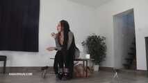 Mistress Cleo squirts cologne into the mouth of the slave lying in the toilet.