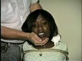 BLACK BANK TELLER IS MOUTH STUFFED, CLEAVE GAGGED & ROPE TIED TO CHAIR  (D46-2)