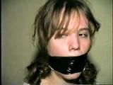 HEATHER IS F0RCED TO TAPE UP HER LEGS AND BARE FEET & IS THEN PANTY STUFFED AND WRAP GAGGED THEN HOG-TIED WITH TAPE ON THE BED (D52-14)