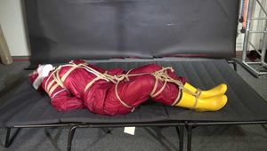Alice bound and gagged in a nylon Rainsuit