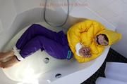 Julia tied and gagged in a ski suit in the bath tub