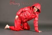 Petra posing in a studio wearing a supersexy red rainwear combination (Pics)