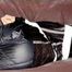 Mara wearing a sexy shiny black rian pants and a sexy shiny black rain jacket tied and gagged with tape and cloth gag on a sofa (Pics)