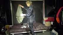 Watching sexy Pia wearing a sexy black shiny nylon jumpsuit reordering rainwear (Video)