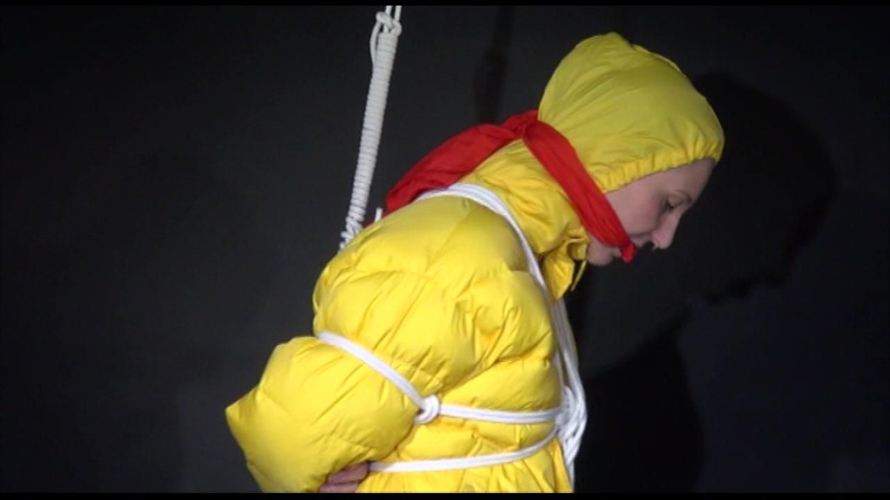 Mara Wearing Sexy Shiny Nylon Rain Pants And A Yellow Down Jacket Crotchroped And Gagged Overhead With Ropes And Clothgags (Video)