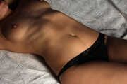Topless barefoot Cheryl is being gagged and cuffed to the bed on-screen