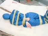 Beautiful archive girl in a blue shiny nylon rainsuit tied and gagged with tape on a sunlounger (Pics)