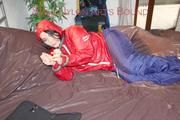 Jill tied, gagged and hooded with a pillory and cuffs wearing sexy shiny nylon rainwear (Pics)