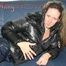 Petra lolling on the sofa wearing a sexy blue rainwear combination (Pics)