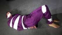 Sexy Sandra wearing a supersexy purple shiny nylon rainsuit bein tied and gagged and hooded on the floor with tape (Video)