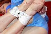 Sonja tied and gagged on bed with ropes wearing a sexy lightblue shiny nylon shorts and a lightblue rain jacket (Pics)