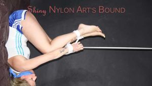 Watching sexy Pia wearing a supersexy blue shiny nylon shorts and a top being tied and gaggedoverhead with ropes and a clothgag (Pics)