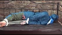 Jill tied and gagged in an old cellar wearing blue shiny nylon rainwear (Video)