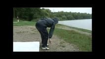 Sexy archive girl wearing shiny nylon shorts and puts on a rain pants and jacket (Video)
